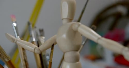 Close Ball-jointed Wooden Man Toy in Blurry Arts Studio