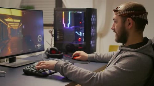 Young Adult Playing Video Game on Computer