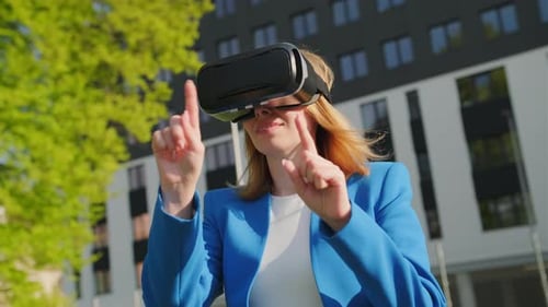 Woman Interacting with Virtual Reality Headset Outdoors