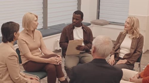 Group Therapy Session with Diverse Adults Sitting in Circle