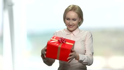 Smiling Woman with Gift Box Gives Birthday Present