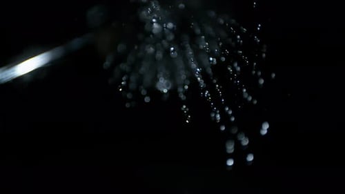 Macro High Speed PoV Template Shot of Downpur of Water onto Camera Lens on Black Studio Background