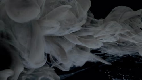 Elegant White Ink Flowing on Black Background