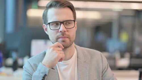 Thoughtful Man Thinking in an Office Setting