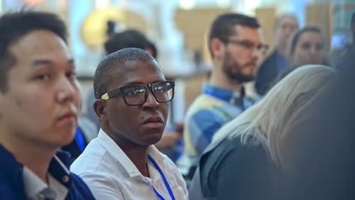 Close Up Shot of Multiracial Forum Audience Listening to Speaker of Lecture Irrl