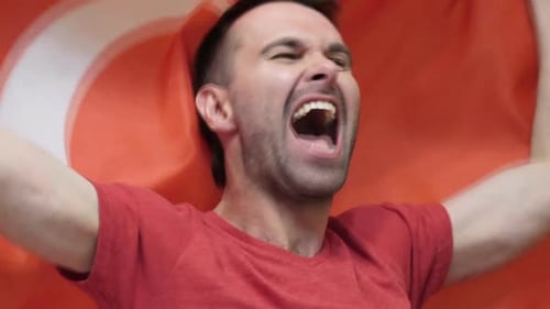 Man Cheering with Flag in Close Up