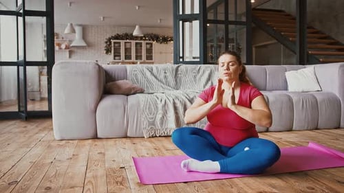 Woman Meditating at Home on Yoga Mat