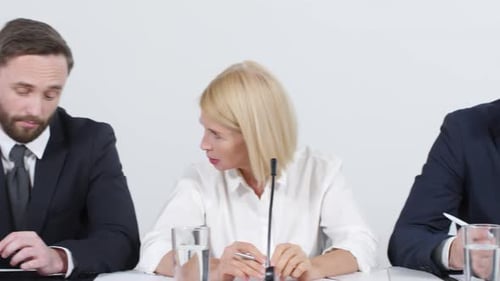 Business People at Conference Speak at Table
