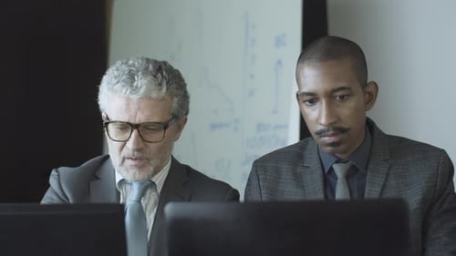 Diverse Male Office Colleagues Working at Workplaces