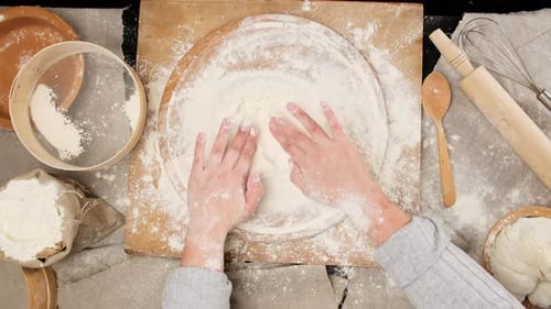 Cook Prepares Flour on Wooden Board