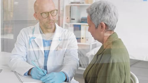 Doctor Consults with Senior Woman in Clinic