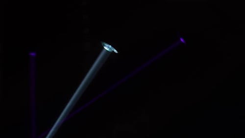 Dynamic Multicolored Light Beams on Black Background