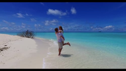 Family of two happy together on relaxing tourist beach lifestyle by blue lagoon and white sandy back