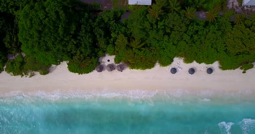 Daytime drone tourism shot of a summer white paradise sand beach and aqua blue ocean background in b