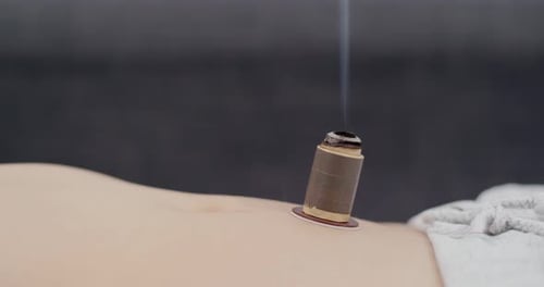 Moxibustion Device Burns atop Person's Stomach