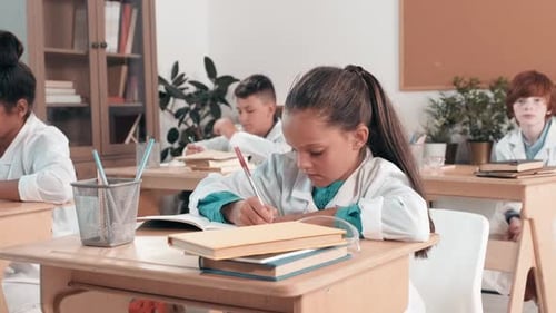Children in Lab Coats Writing in Classroom
