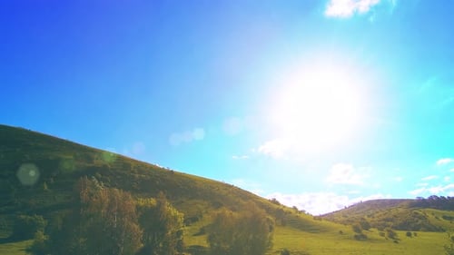 UHD Mountain Meadow Timelapse at the Summer. Clouds, Trees, Green Grass and Sun Rays Movement