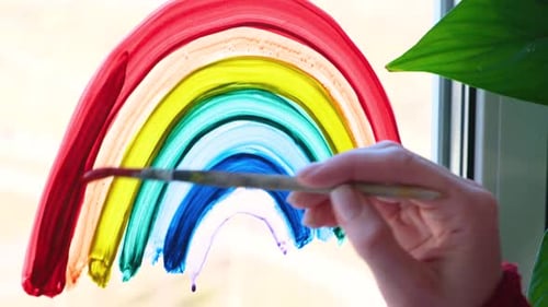Painting a Colorful Rainbow on Window at Home
