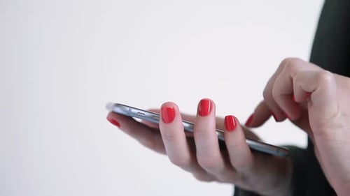 Woman's Hands Using a Silver Smartphone