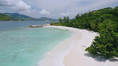 Aerial Approaching View of Lonely Tourist Boat Moored in Tropical Exotic Blue Lagoon with Clear Blue