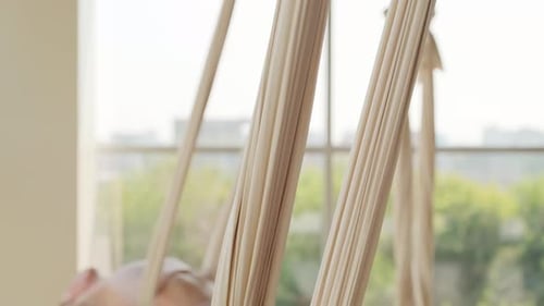 Women Relaxing in Aerial Yoga Hammocks