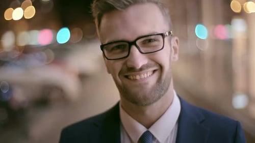 Smiling Man in Suit in City at Night