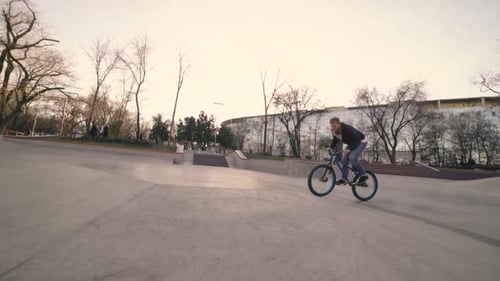 MTB Bicycle Rider Does Various Tricks While Riding in Skatepark
