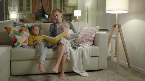 Mother Reading to Children in Cozy Home
