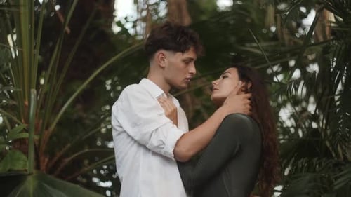 Young Couple Embracing Tenderly in Tropical Setting