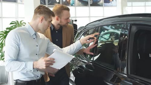 Men Examining Car at Dealership Showroom