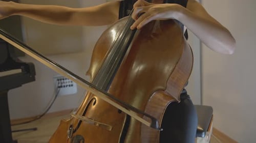 Woman playing Cello in Music Room