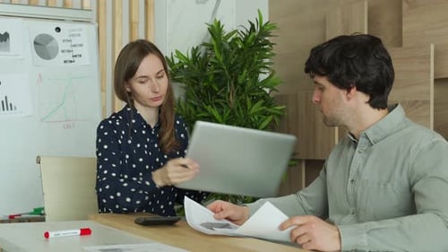 Two Business People Talk Project Strategy at Office Meeting Room