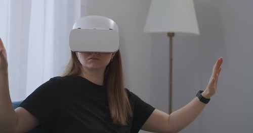Woman Enjoys Virtual Reality Headset in Living Room