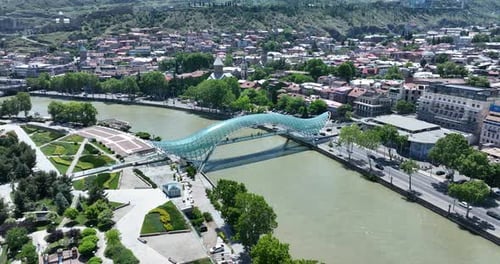 Aerial view of Tbilisi city central park and Bridge of Peace. Beautiful cityscape of old Tbilisi