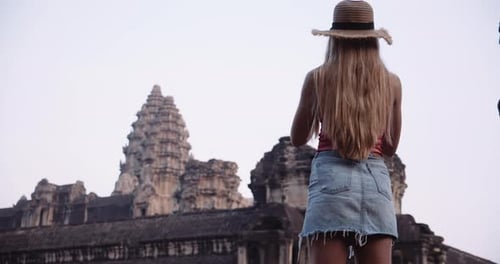 Blonde Tourist Takes a Camera Phone Out to Capture a Scenic View