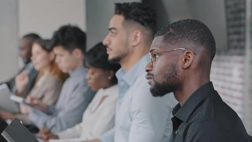 Diverse Professionals Attending Meeting in Workplace