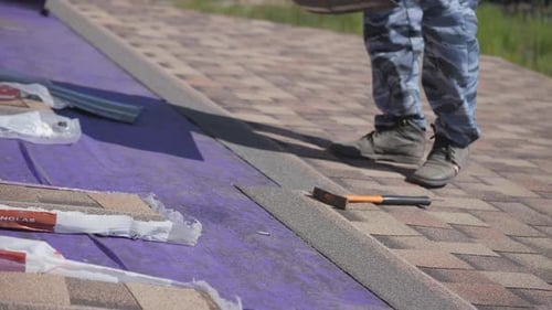 Roofing Work. Laying a Soft Roof on the Roof of a Private House.