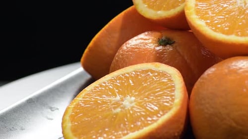 Fresh and Naturals Oranges Gyrating on a Black Tray