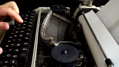 Fingers Typing on a Retro Typewriter Keyboard