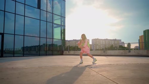 Energetic Child Dancing in Urban Sunlight