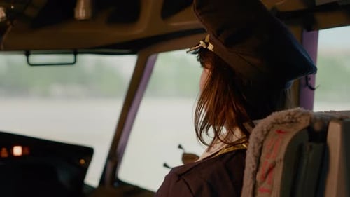 Portrait of Female Copilot in Aviation Uniform Flying Airplane