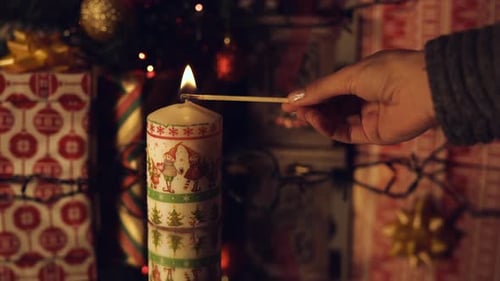 Hand lighting a candle
