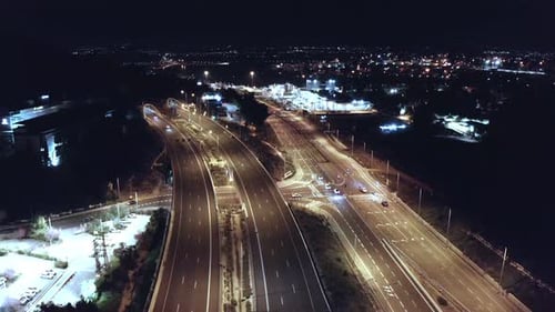 Foto aérea nocturna de una carretera en mal estado con tráfico en todos los carriles y semáforos