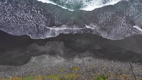Aerial View of Beautiful Beach with View of Ocean Waves and Water Crashing on to Sandy Shore From