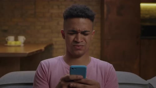 Young Adult Using Phone Inside Home