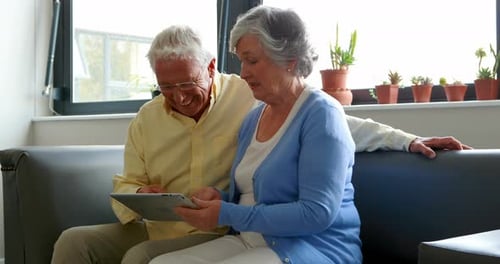Senior Couple Enjoys Tablet Together at Home