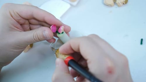 Hands Working on Dental Molds in Workplace