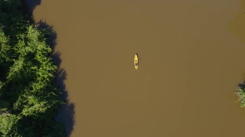 Kayaker Rowing Along Tropical River in Pantanal Brazil