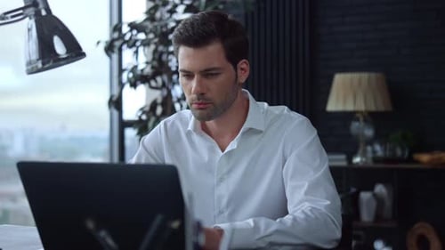 Businessman Using Laptop Computer in office.Employee Typing on Computer Keyboard