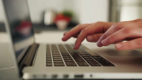 Close Up of Woman Typing on Laptop Keyboard